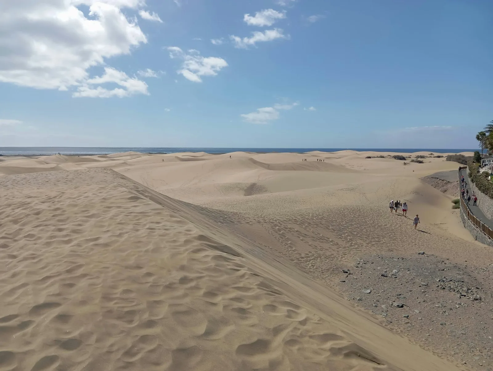 Wooden walkway through the Maspalomas dunes towards the lighthouse in southern Gran Canaria
