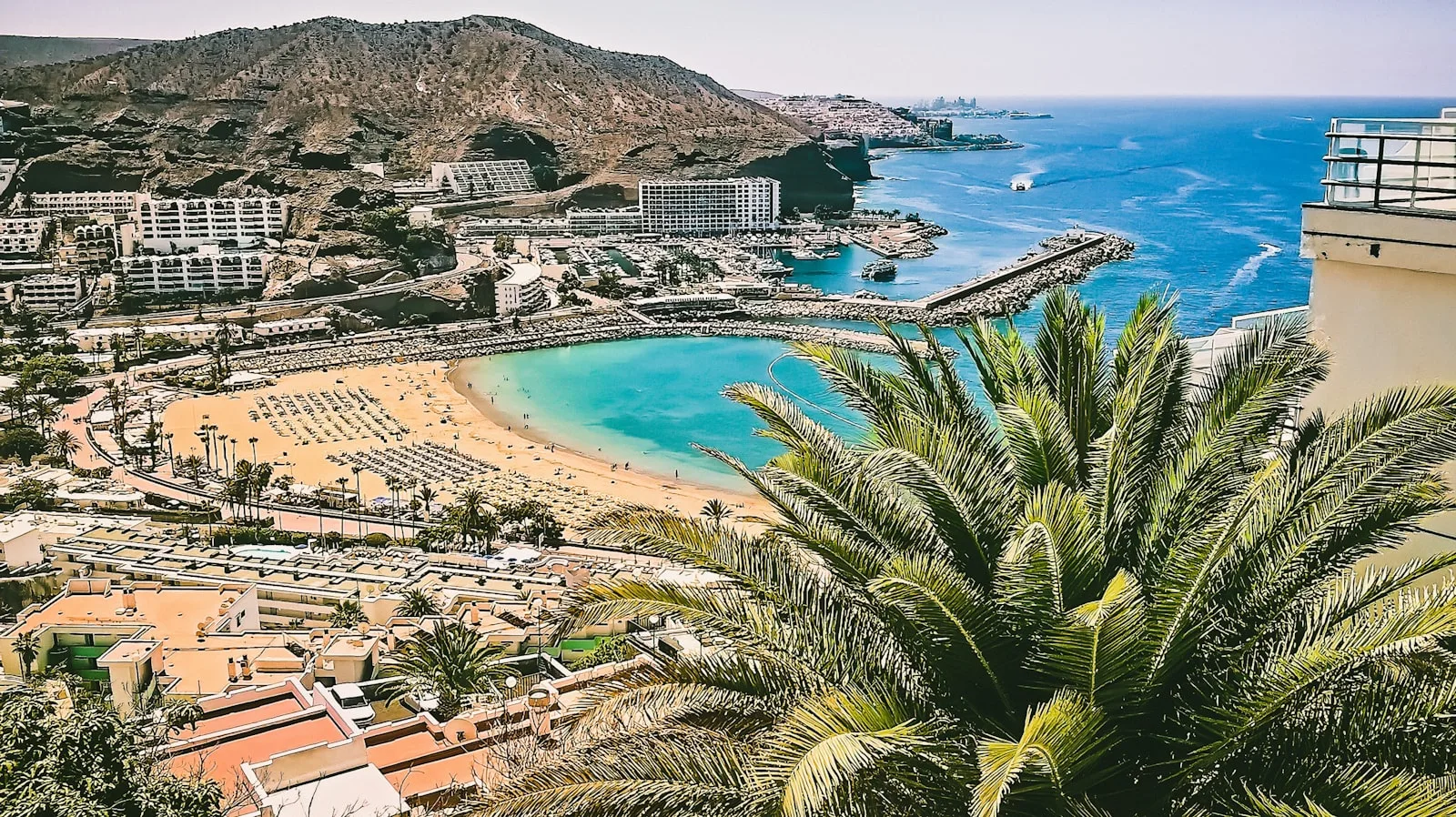 Aerial view of a sheltered resort beach on the south coast of Gran Canaria
